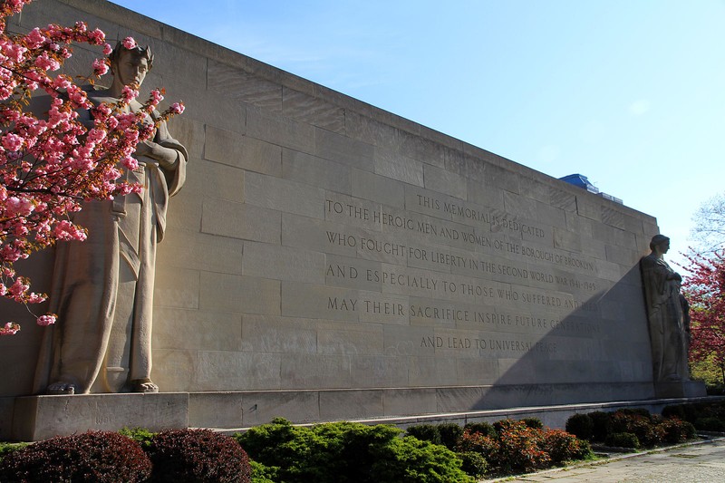 The writing seen in this picture dedicates the monument to the Brooklyn service men and women of World War II.