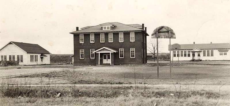 A black and white photo of a schoolhouse.