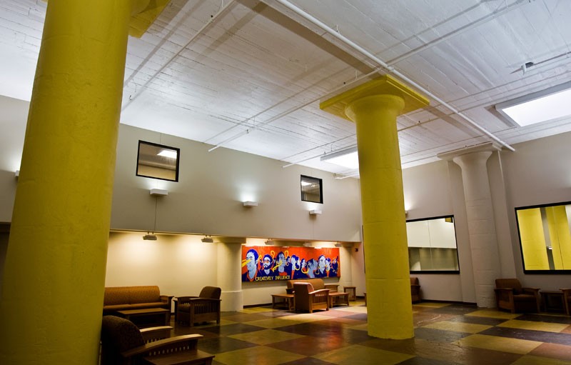 The lobby of Shannon Hall features rotating student art exhibits and its original concrete mushroom columns.