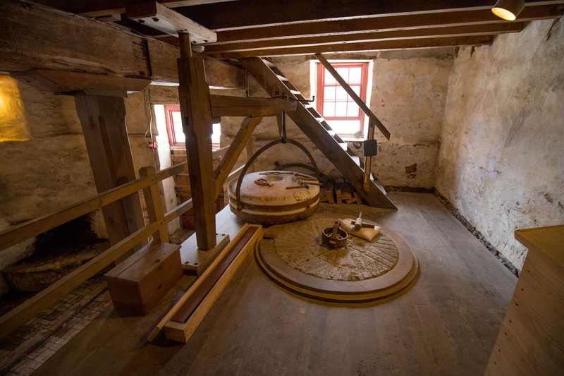 Image of a set of millstones that have been taken apart for maintenance.