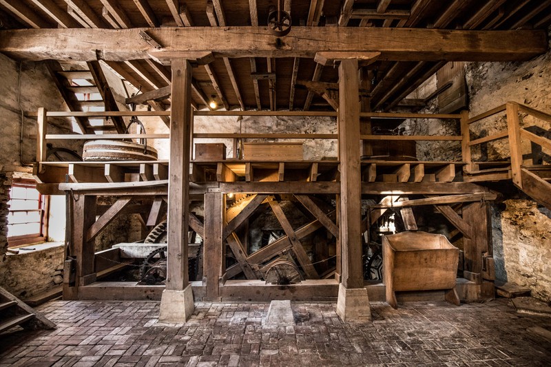 Image of a wooden frame with wooden and iron gears.