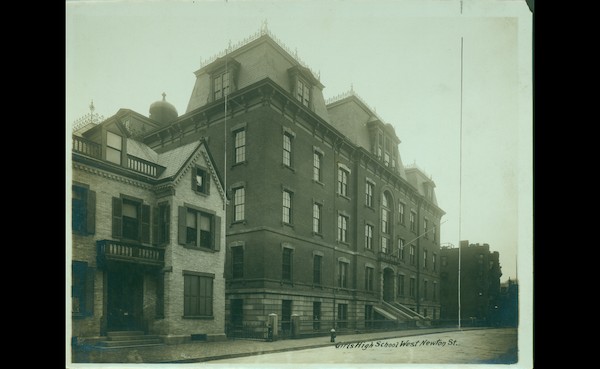 Black & White photograph of a brick building with a mansard roof.