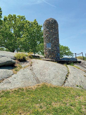 The cairn is located atop Quincy’s Penn’s Hill, at the corner of the Viden Road and Franklin Street, and up the hill from the Adams Presidential Birthplaces (Adams National Historical Park) in Quincy MA