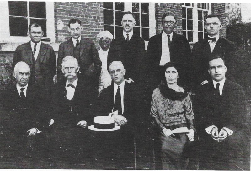 Black and white photo, people sitting and standing