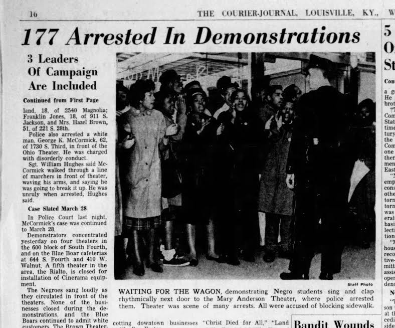 Students arrested outside the Mary Anderson Theater wait for the wagon to take them.