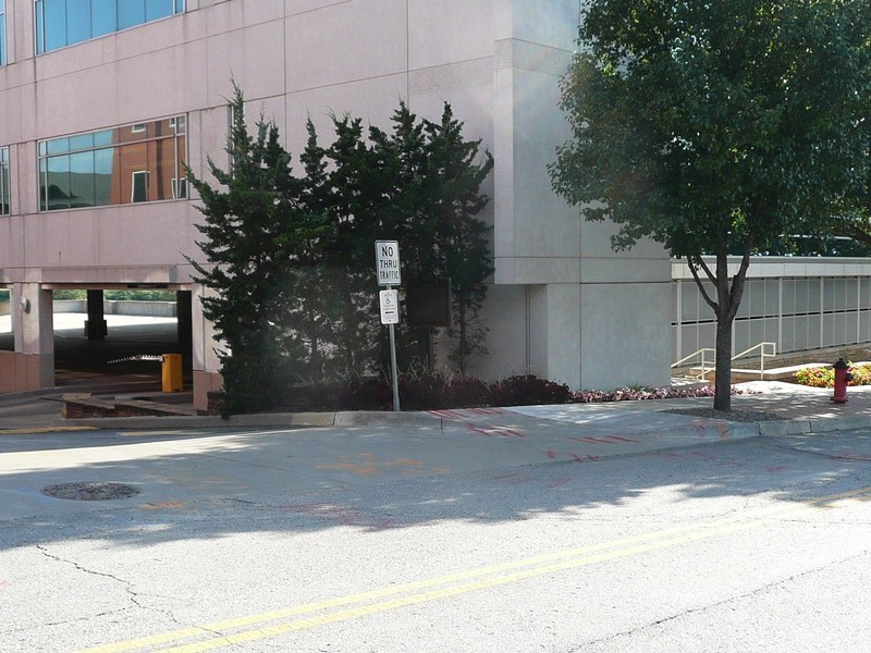 The marker is located beside a parking garage, near the original site of the cemetery. Image obtained from the Historical Marker Database. 