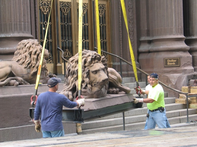The bank's original lions being removed for restoration in 2009.
