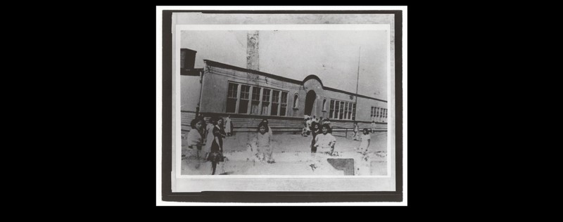 Mexican children standing outside Clara Barton. The school served the segregated Mexican community from the 1920s until the flood of 1951. 