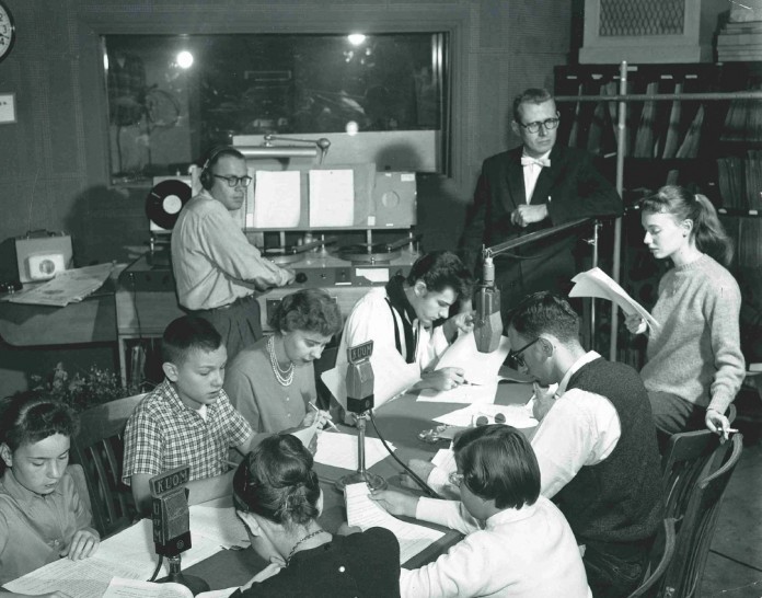 Workers in the KUOM studio in 1959, located in the Eddy Hall basement