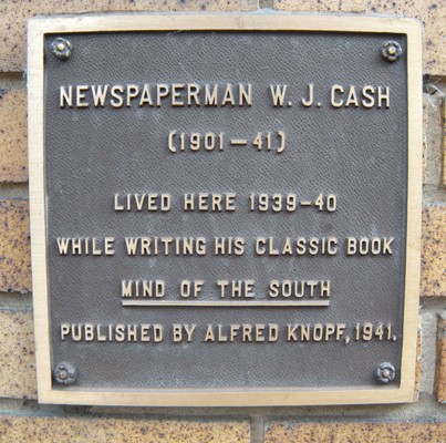 Plaque acknowledging the apartments as the former home of W. J. Cash. The plaque states that Cash lived in the apartments from 1939 to 1940, but Cash in fact moved into the apartment in 1938.