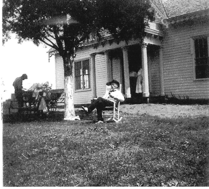 Judge Joseph Lowe sits in front of the home, circa 1913