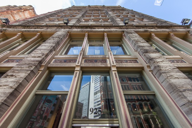 Looking up the rusticated façade of the Ewart Building.