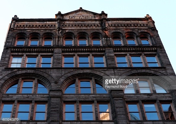 A closer view of the Ewart Building's Romanesque arches and triangular pediment. 