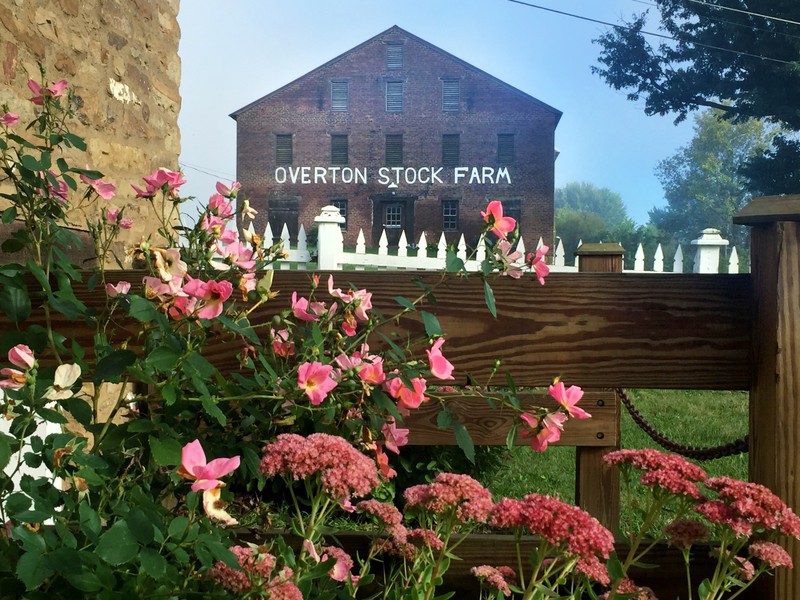 A brick barn and gardens at West Overton. Photo by West Overton Village.