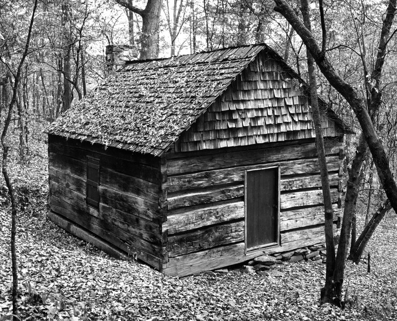 The Heritage Cabin in its original location prior to being moved to campus.