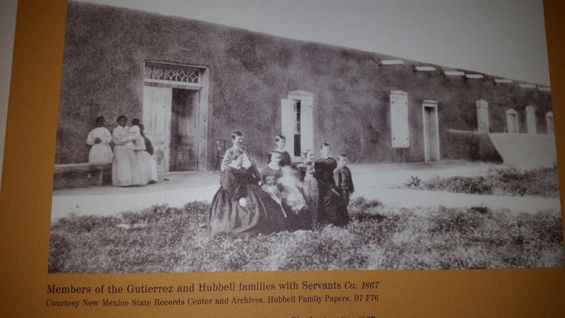 Circa 1867 photo of members of Hubbell family in front of home with servants in back