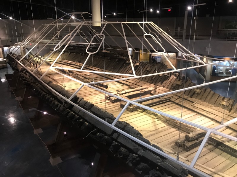A picture of what remains today. The wooden hull is all the remains and white bars outline where the rest of the ship would be and what it would look like.