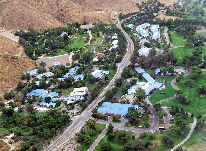 	
Aerial view of Gold Base from the west, showing the garage in the foreground, with Massacre Canyon Inn behind and the Staff Berthing buildings beyond, to the right of the highway. The buildings in the foreground on the left of the highway are mostly us