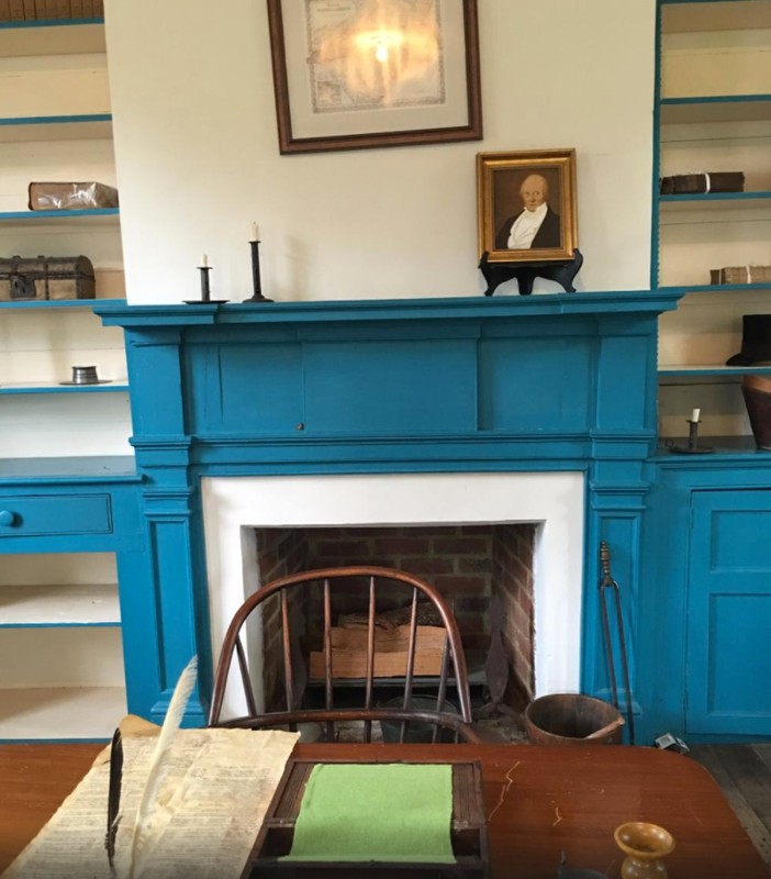 A closeup of a writing desk and fireplace in the Badger Iredell Law Office.