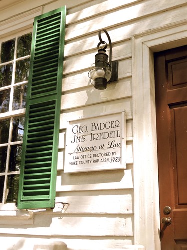 A sign that reads, "GEO. Badger, JMS. Iredell: Attorneys at Law: Law Office Restored by Wake County Bar Assn. 1983"