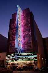 The Paramount's neon sign lit up at night time. 