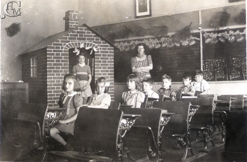 Teacher, Mrs. Brick with students in a classroom from about 1943.
