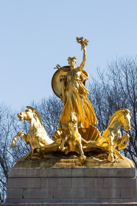 A close-up of the gilded bronze statue atop the monument 