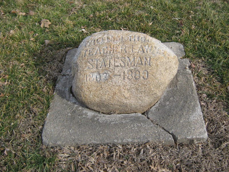 The stone marker honoring William Thomas. 300 Block of West College Ave, across from the Mason's Building.