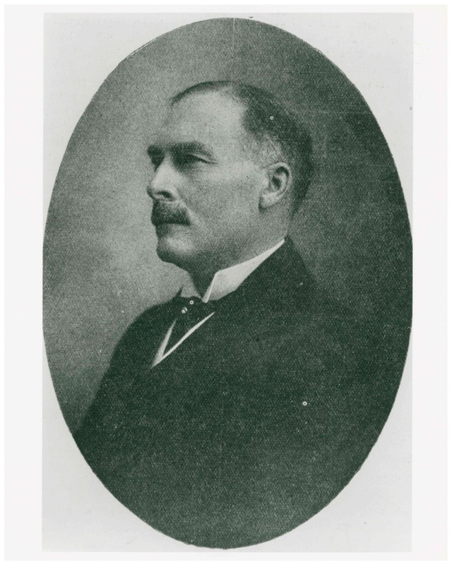 Black and white portrait photo of man with mustache