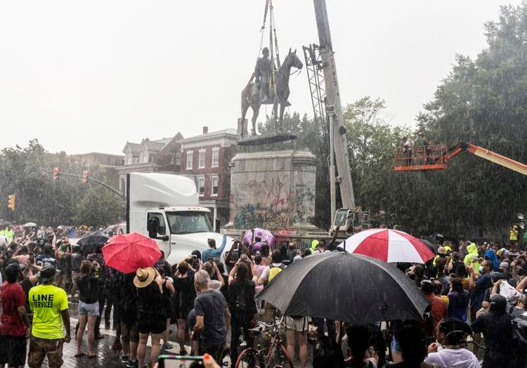 A crowd watches the removal of the Jackson statue in July 2020