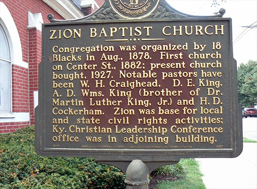 This historical marker is located next to the church