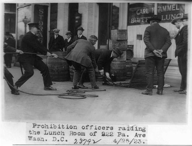 A photograph showing Prohibition officers conducting a raid on bootleggers.