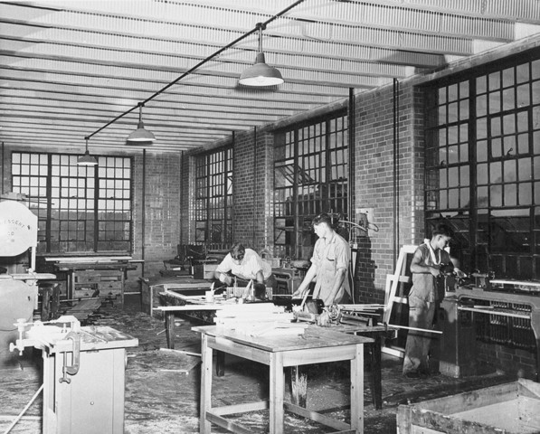 This image depicts young men at the facility in the shop at around mid-century.