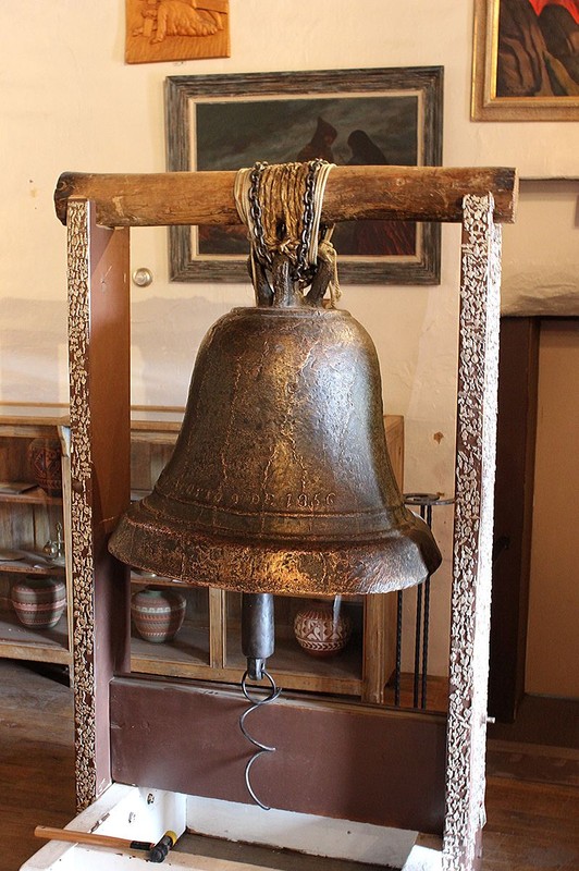 Original thick-walled church bell within San Miguel Mission at Santa Fe, New Mexico with the inscription "San Jose Rogad Por Nosotros Agosto 9 de 1356/1856" in English, the bell reads "St. Joseph Pray for us August 9th, 1356/1856". It is thought that