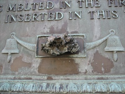 Close up of he plaque with a piece of the original melted bell 