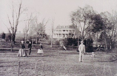 A game of croquet being enjoyed on the lawn. 