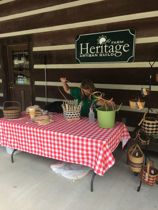 Basket weaving on the front porch of the Artisan Center.