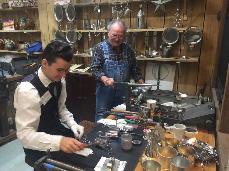 Tinsmithing in the Artisan Center.