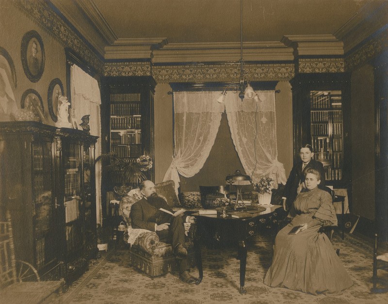 The Stark family, W.H., Miriam, and H.J. Lutcher Stark posing in their library c.1900.