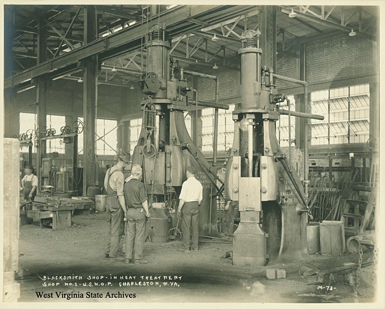 Blacksmith Shop inside the U.S. Naval Ordnance Plant in early operation. The plant was designed to be entirely self-sufficient in the production of steel armor, gun barrels, and projectiles. WV State Archive.