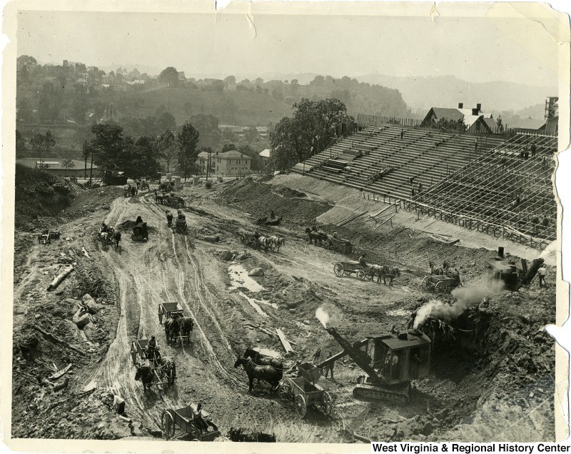 Workers and horses excavate Mountaineer Field, ca. 1924.