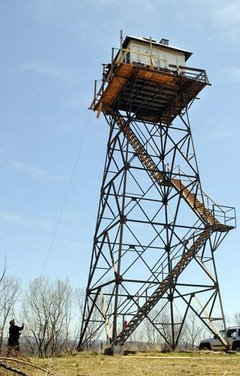 The refurbishing of Thorny Mountain.  Materials were hauled up to the cab by rope and pulley, as supplies would have been during the days of the tower's operation.   Photo by Chris Dorst.