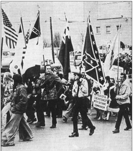 Anti-textbook protesters on the march in a photo from the Charleston Gazette.  One protester's sign states, "No peaceful coexistence with satanic communism."  