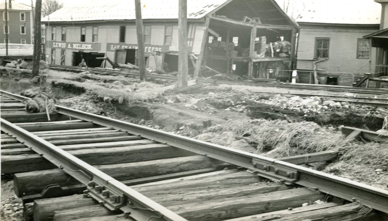 One of the businesses which suffered extensive damage from the flood of 1936 was the Nelson Grain Mill, which was sheared in half. Also visible in the photos is the damage to the railroad tracks. 