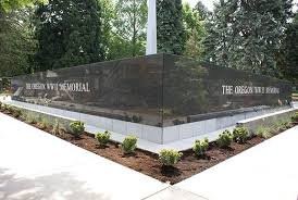 This view is a good shot of the V-shaped Black granite wall that is seen by visitors as they approach the memorial monument.