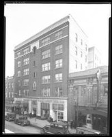 Shown is 608 W Walnut St (now Muhammad Ali Blvd), Louisville, Kentucky. The building in the center is the Mammoth Life and Accident Insurance Company (also owned by William H. Wright) with the American Mutual Savings Bank to the right.