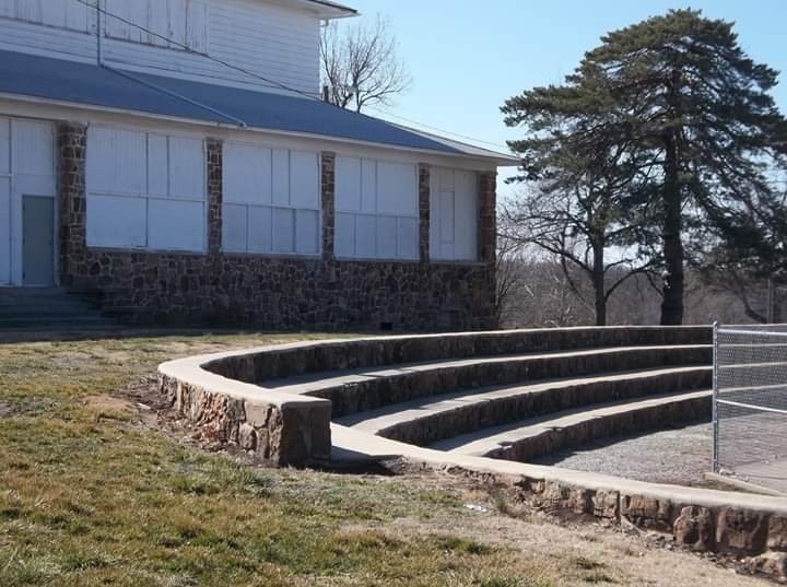 WPA-built former park pavilion (now skating rink) in background and rock seating for swimming pool in Municipal Park.