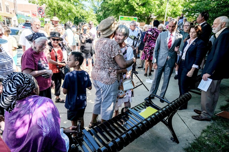 Pam Horowitz, center, surrounded by friends and activists at the dedication of the bench in her husband's memory on June 26, 2017.