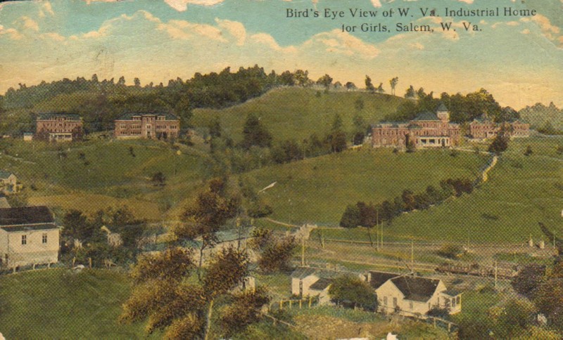 Color postcard of a bird's eye view of the West Virginia Industrial Home for Girls in Salem, WV. The industrial home campus is situated on the hill above the town. Courtesy of Harrison County WV Historical Society 