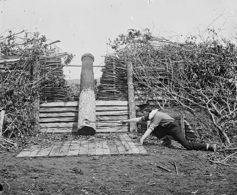 A "Quaker gun" in Centreville, Virginia, in March 1862; the man in the picture is pretending to "fire" it